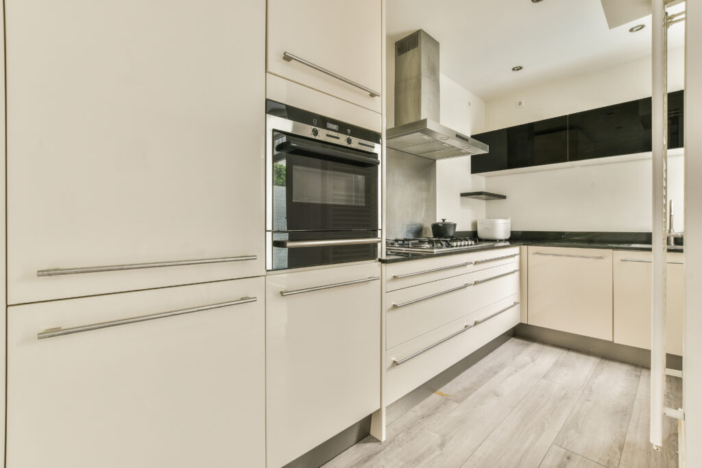 Modern kitchen with stainless steel appliances and quartz countertops.